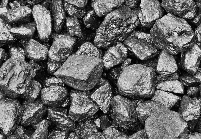Close-up of raw Shanxi bituminous coal chunks with a dark, metallic luster and irregular textures.
