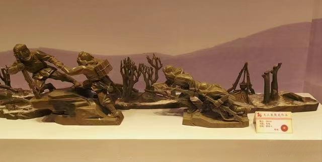 A military themed historical sculpture carved from greenish-brown Panlong jade.