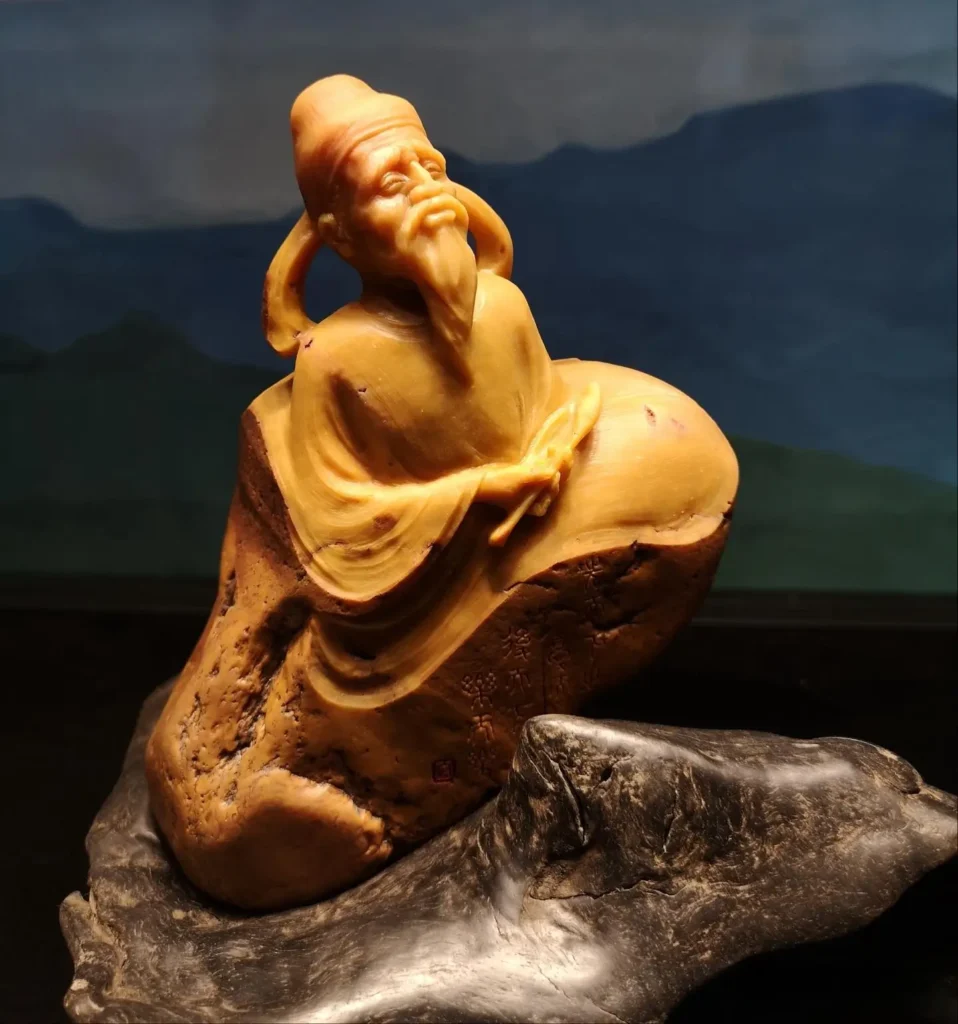 A scholar figure carved from emerging stone carving materials, Yellow Wax Stone.