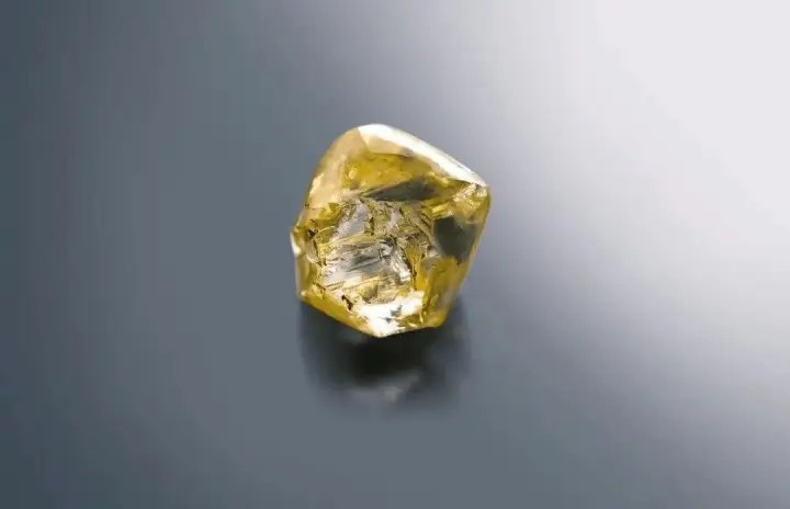 A natural yellow rough diamond crystal from Yuanjiang, Hunan, showcasing adamantine luster.