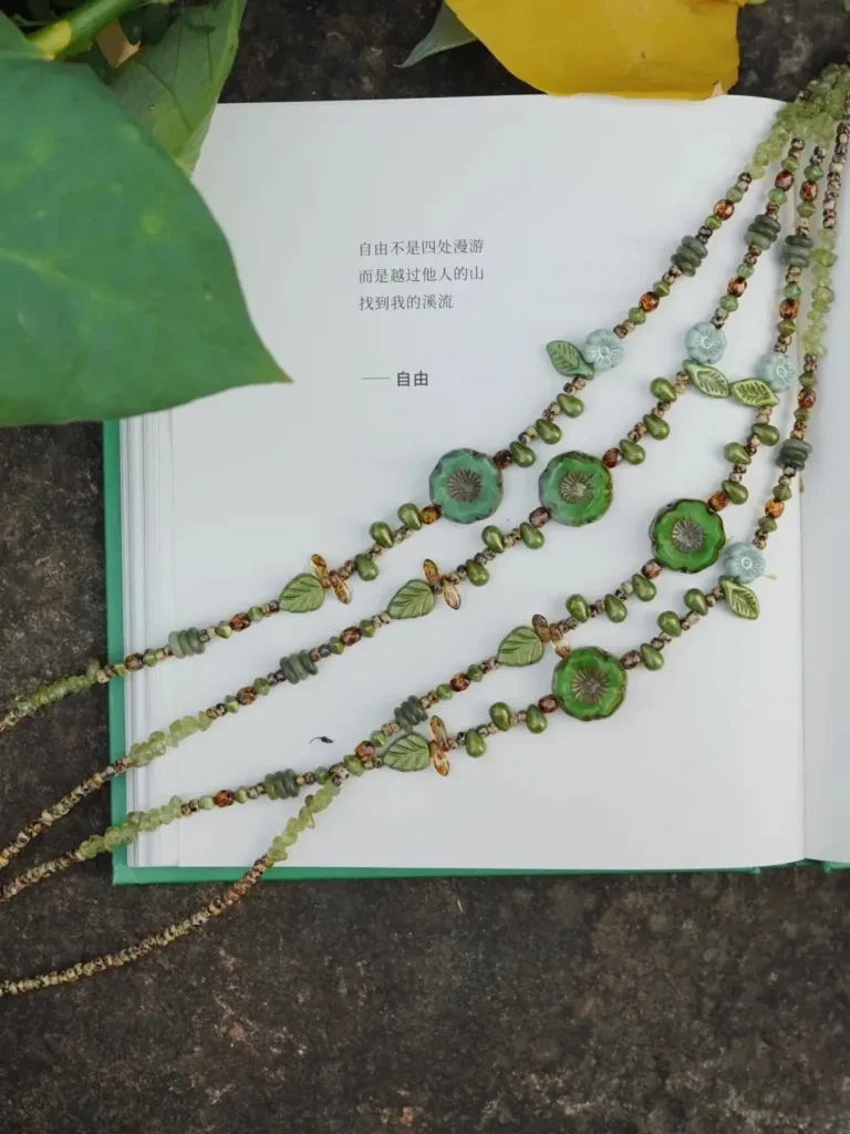 Four Wilderness Bracelets made with green Czech glass beads and floral bead details.