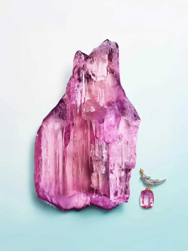 A 7,500-carat rough spodumene crystal next to a Tiffany Bird on a Rock brooch.