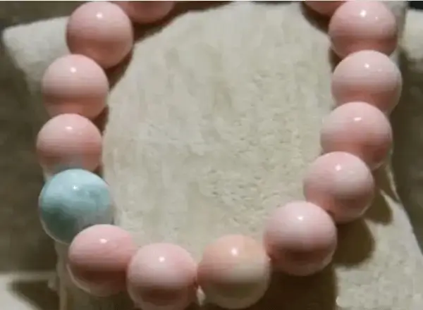 Dyed freshwater pearl mussel shell beads showing uniform pink color and polished surfaces.