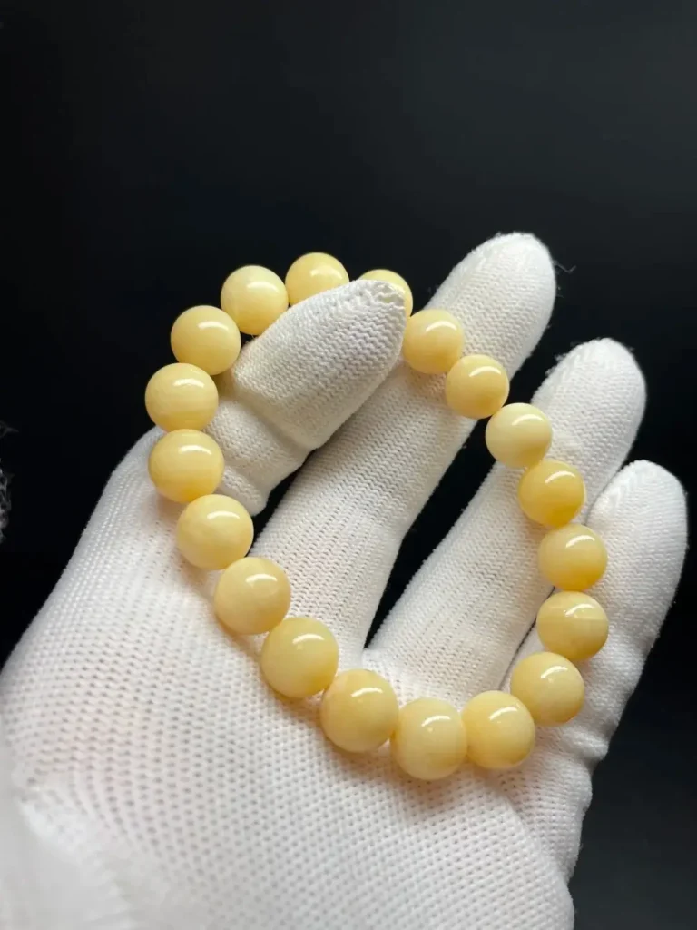 16mm Golden Tridacna shell bracelet with smooth round beads in a natural golden-yellow tone.