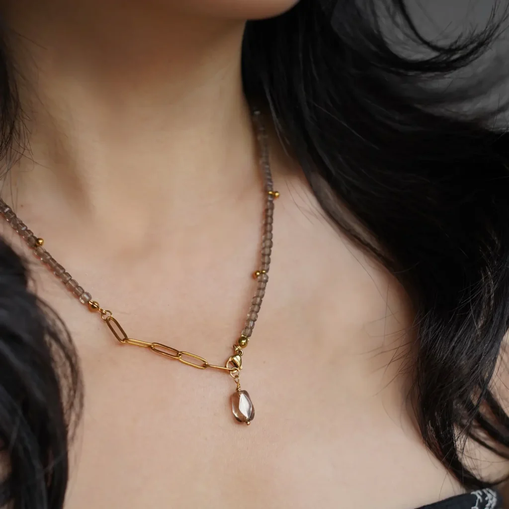 Close-up shot of a woman wearing a handmade beads Y-drop necklace.