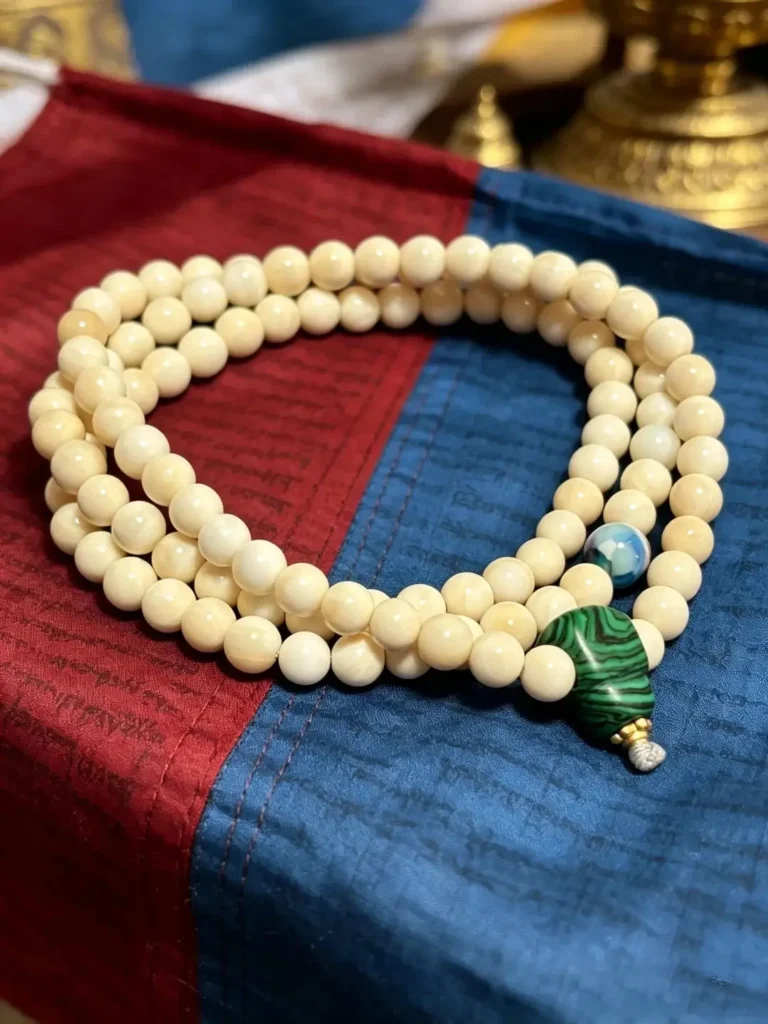 A strand of 108 Tridacna shell prayer beads jewelry with smooth cream-white polished beads.