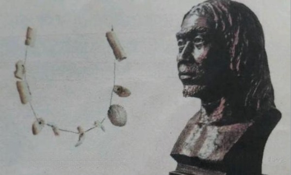Upper Cave human reconstruction beside pierced shell ornaments from the Zhoukoudian site.