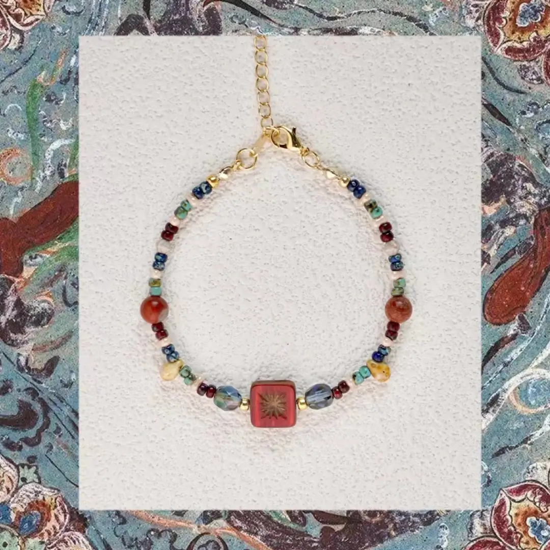 Vintage Czech glass beaded bracelet centered on a background of Dunhuang mural art.