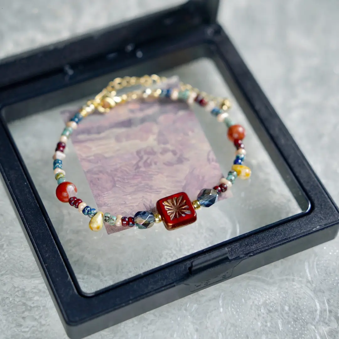 Vintage Czech glass beaded bracelet displayed in a black box with an artistic card backdrop.