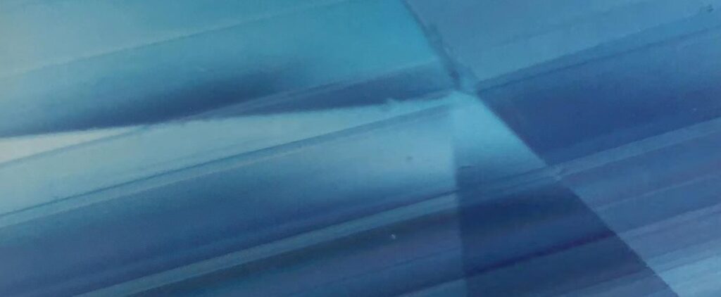 Densely arranged parallel and intersecting twin planes inside a blue Burmese sapphire