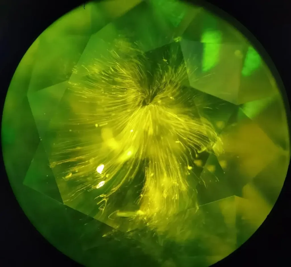 Demantoid garnet showing distinctive horsetail-like inclusions inside the gemstone.