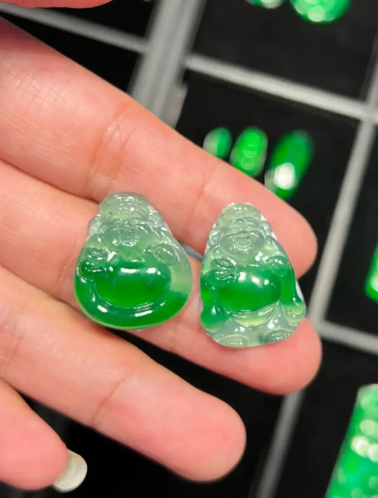 Two icy Guatemalan jadeite Ruyi pendants with white bases and floating green patterns.