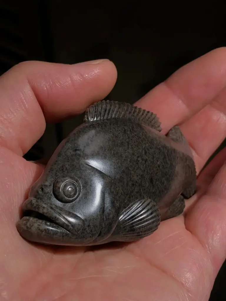 Seed jade fish carving featuring natural mottled Yi Tang sugar-color patterns.