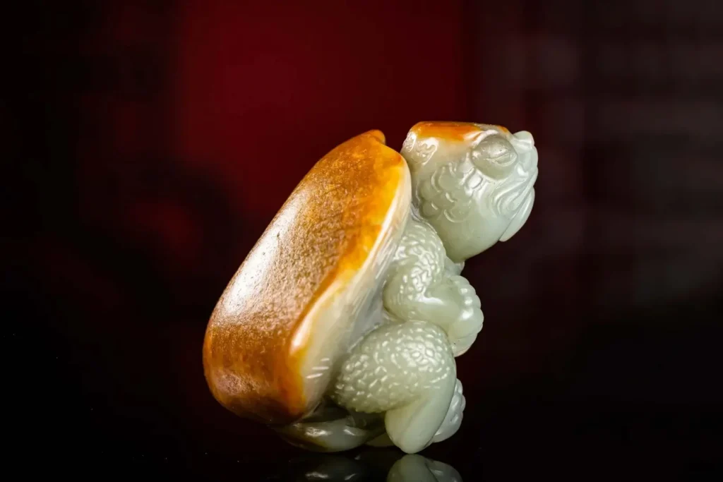 Celadon Hetian jade turtle carving using natural yellow-brown Jiang skin as the shell.