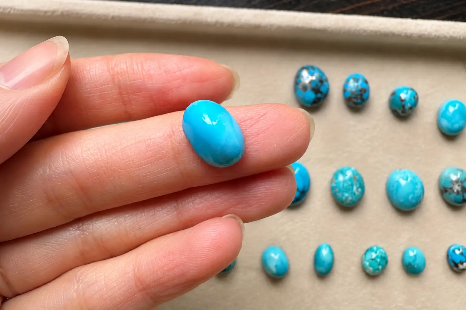 Iranian Persian turquoise cabochon showing natural blue color and smooth polished surface.