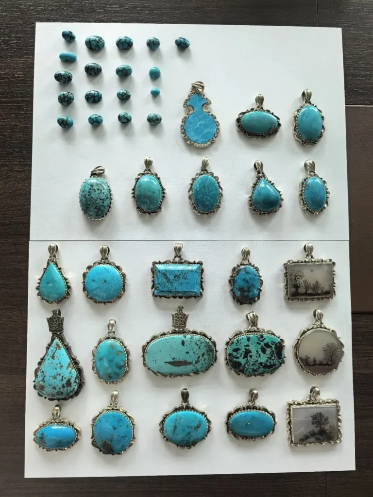 Iran gemstones collection featuring turquoise silver pendants and small gemstone pieces.