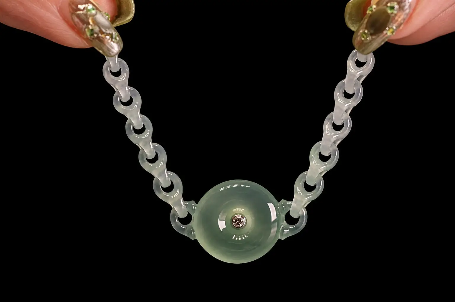 Hand-carved jade chain bracelet with translucent interlocking links and a round jade centerpiece.