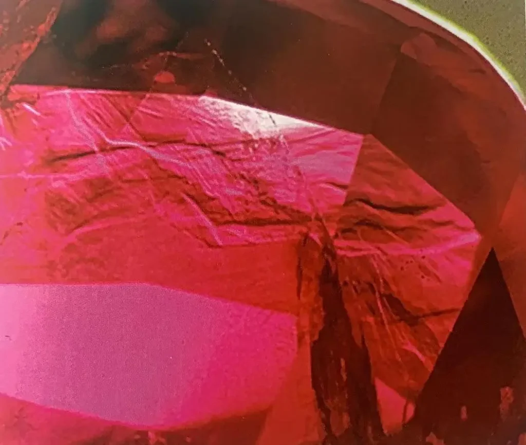 Swirling and flowing color zoning patterns inside a red Mogok ruby from Myanmar under magnification.