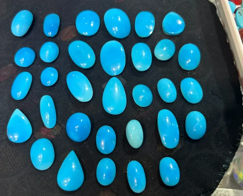 Neyshabur turquoise gemstones in various cuts displaying a pure sky-blue color.