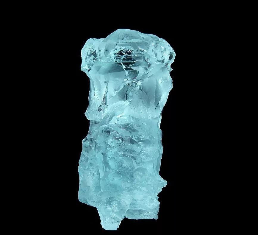Light blue Aquamarine rough crystal from Pakistan on a dark background.