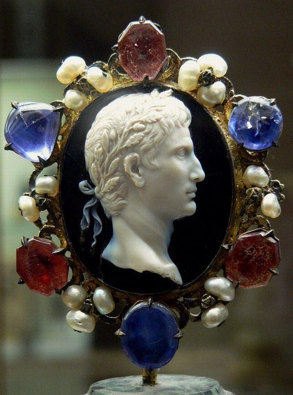 Ancient Roman sardonyx cameo showing Emperor Augustus in profile with a white raised relief portrait.