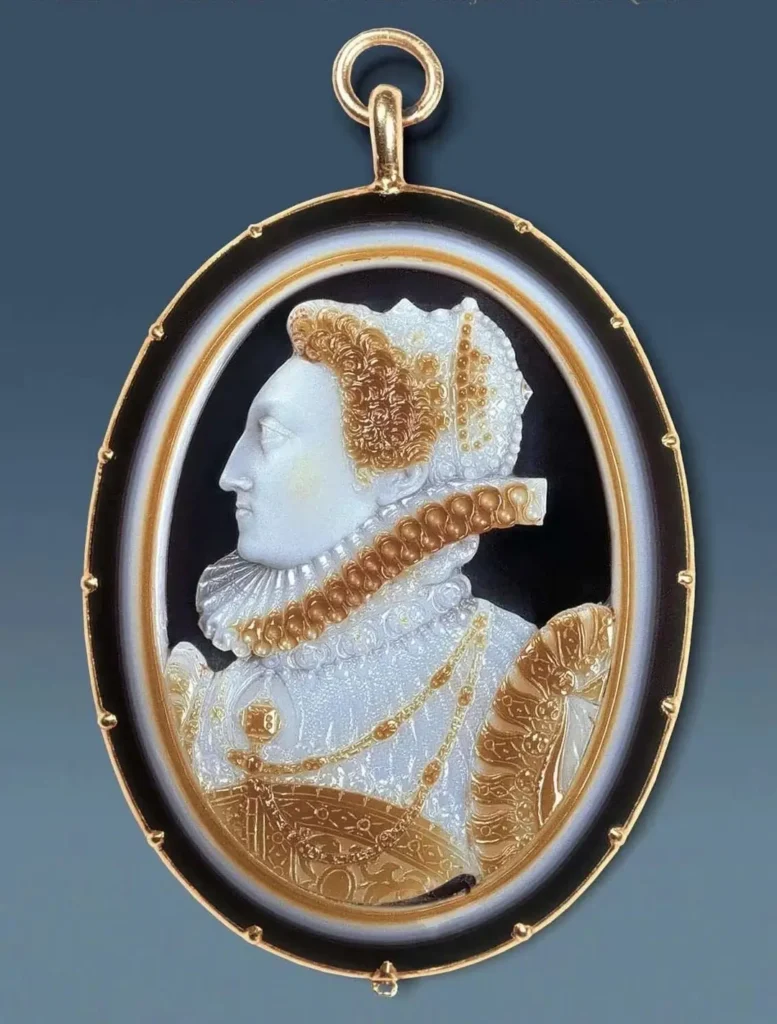 Historical cameo pendant featuring a carved portrait in raised relief with decorative metal details.