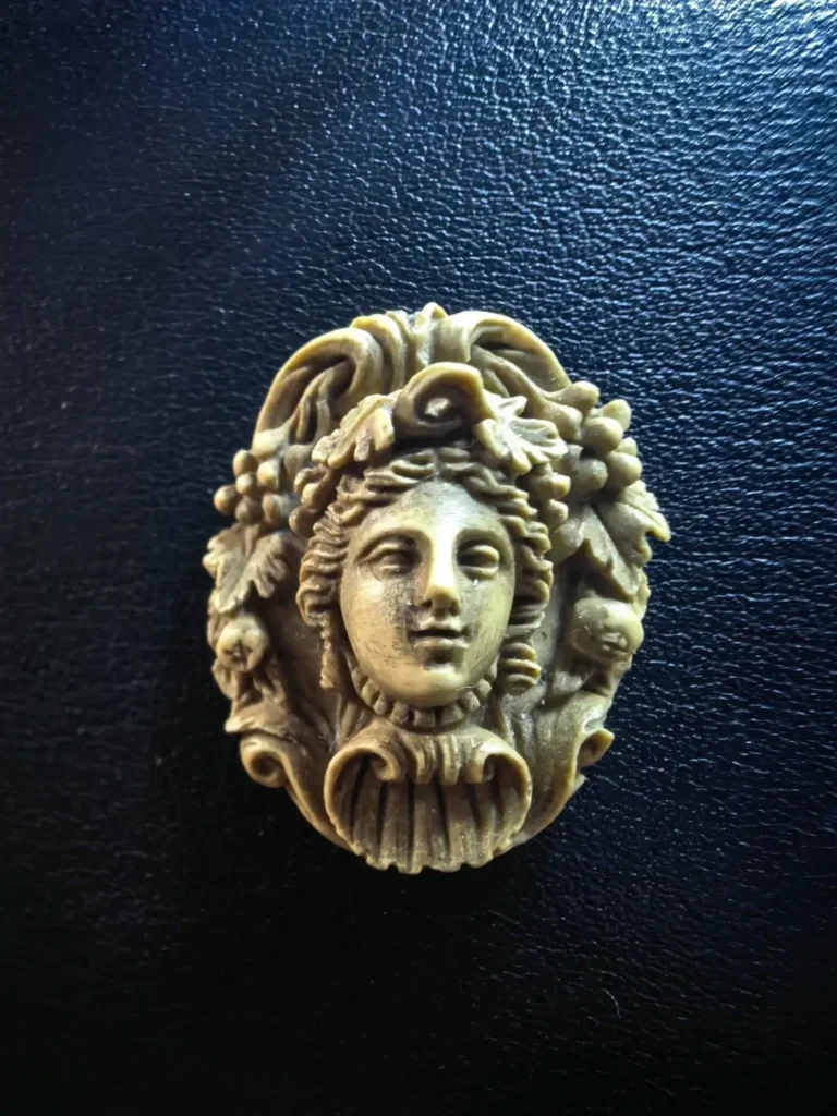 Victorian lava stone cameo featuring a deeply carved front-facing Bacchante portrait.