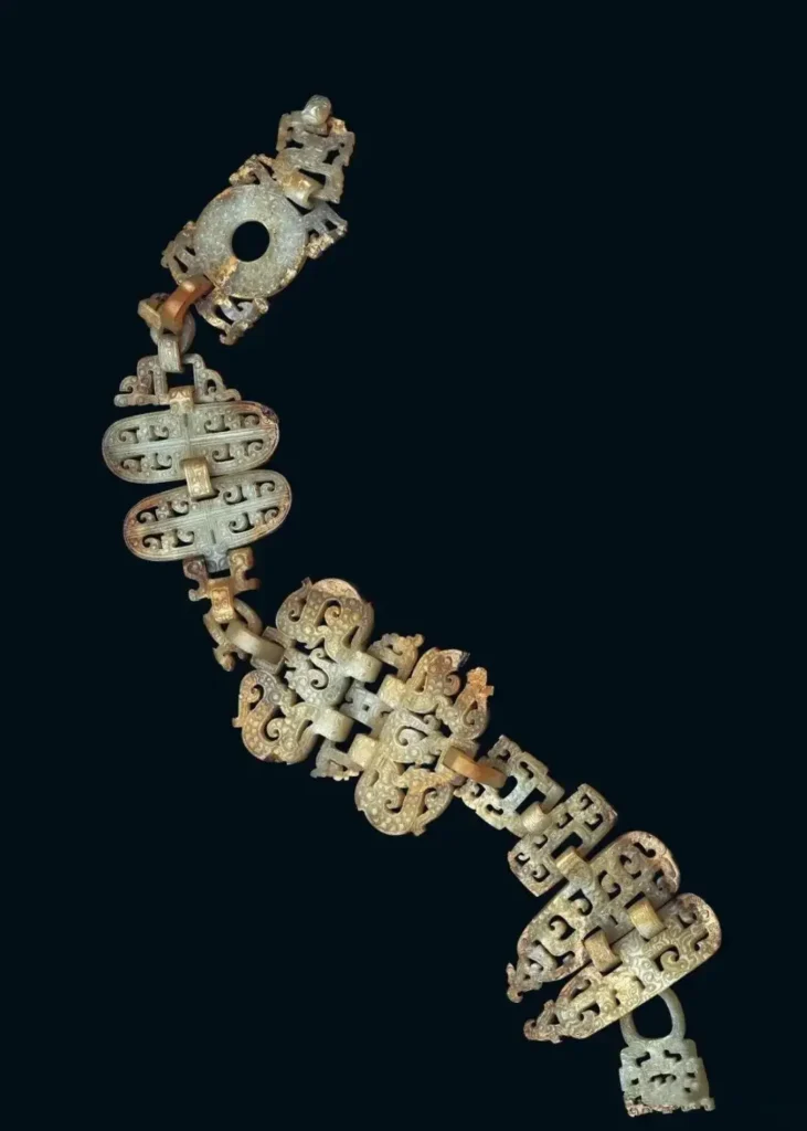 Warring States jade pendant with multi-segment design and intricate dragon and phoenix motifs.
