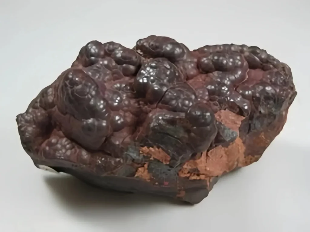 Dark hematite mineral specimen with a metallic botryoidal surface