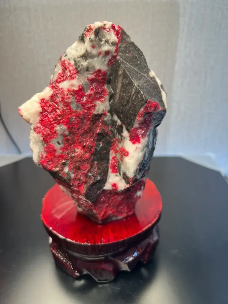 Red cinnabar mineral embedded in white and gray host rock.