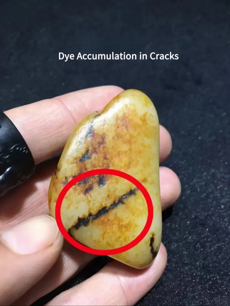 Dye accumulation visible in cracks of imitation Hetian seed jade skin.