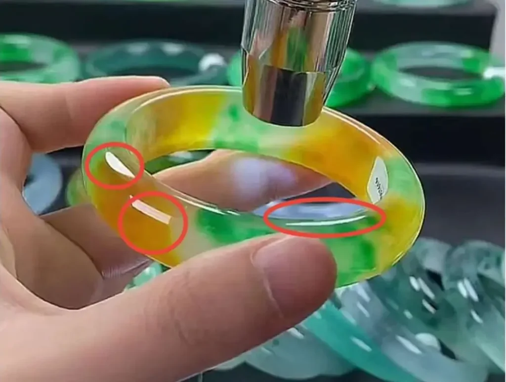 Dyed Dulong jade showing no visible fluorescence under UV light in a livestream setting