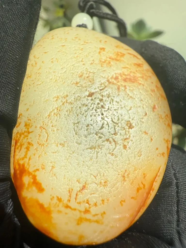 Hetian seed jade with yellowish-brown coloration along nail-shaped marks