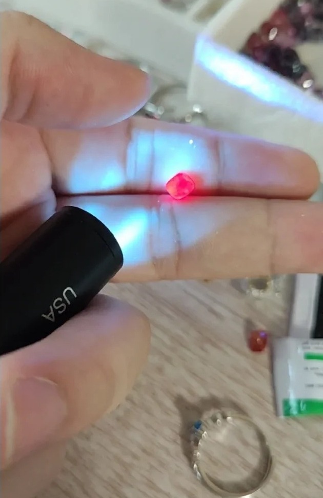 Natural red spinel showing fluorescence under UV light