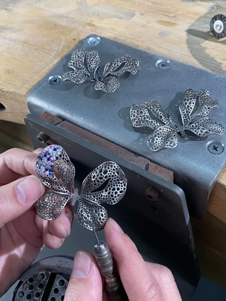 Jewelry artisan setting a titanium jewelry piece by hand