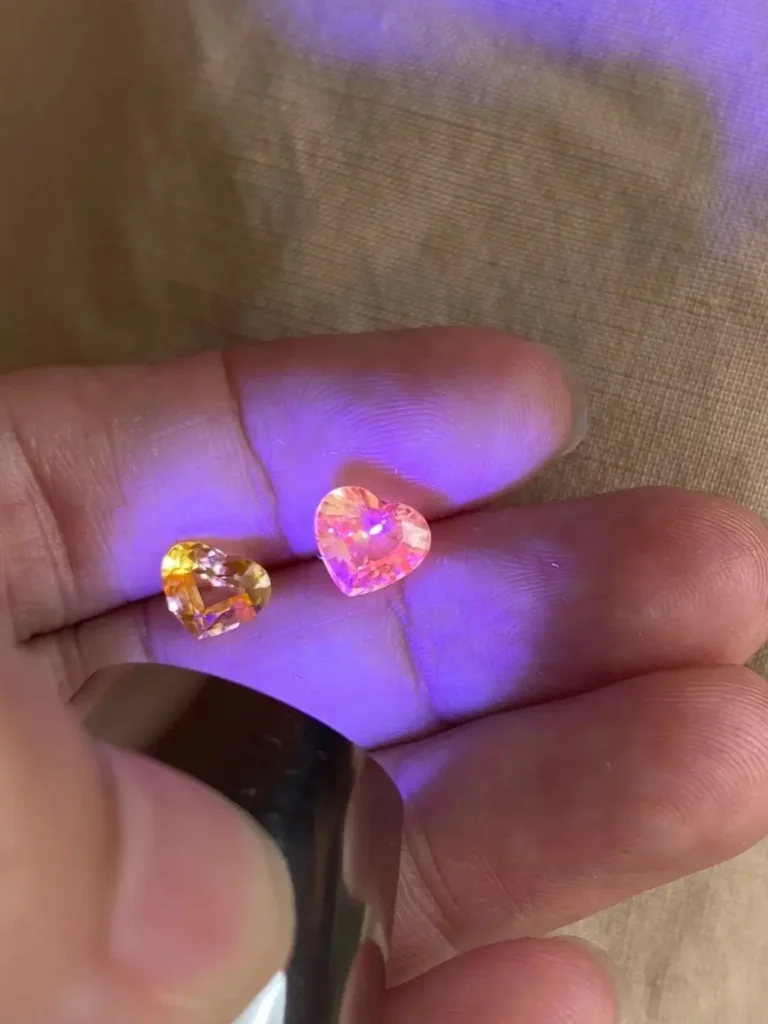 Two yellow sapphires showing different fluorescence under UV light