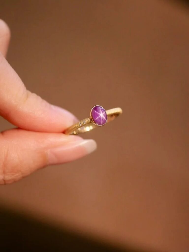 An 18K gold ring set with a 1.03-carat unheated purple gemstone.
