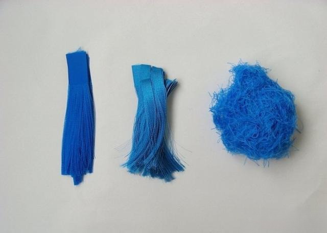 Neatly arranged blue satin ribbon threads prepared for making faux kingfisher feather strands.