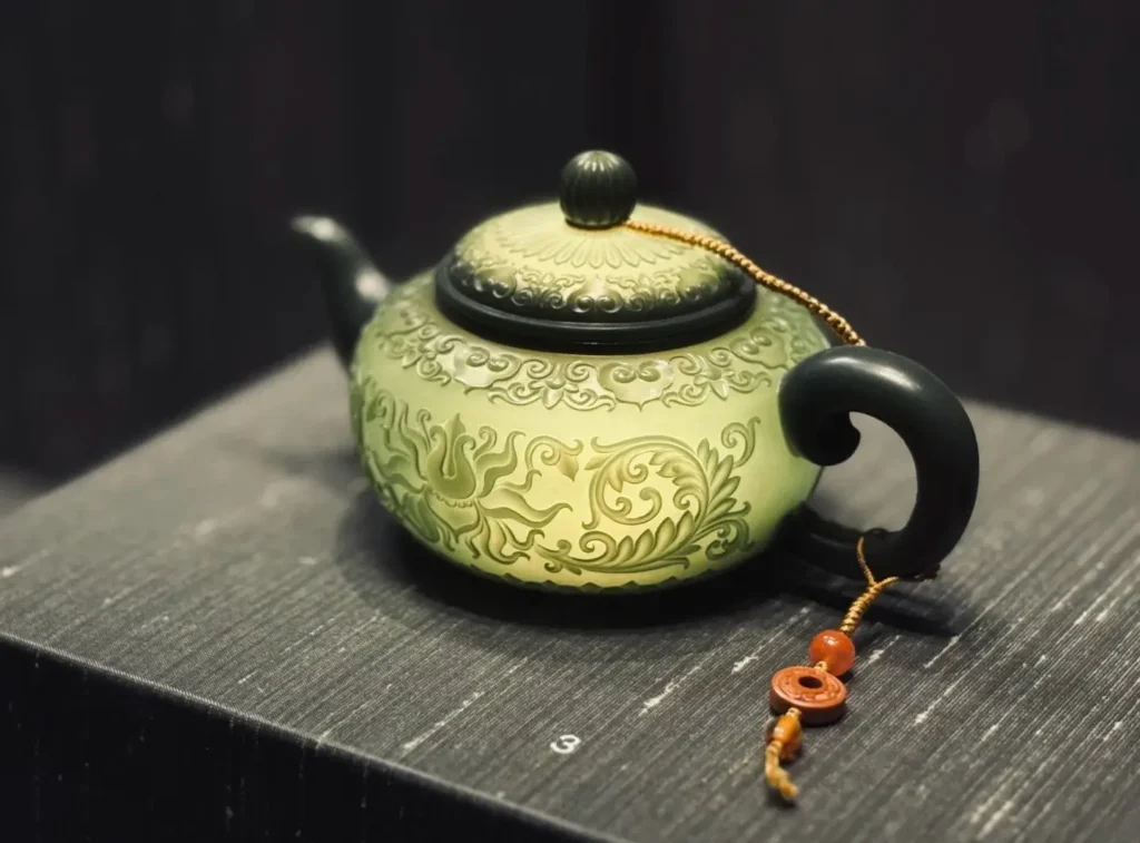 Bluish-green nephrite thin-walled teapot with vine carvings and strong translucency