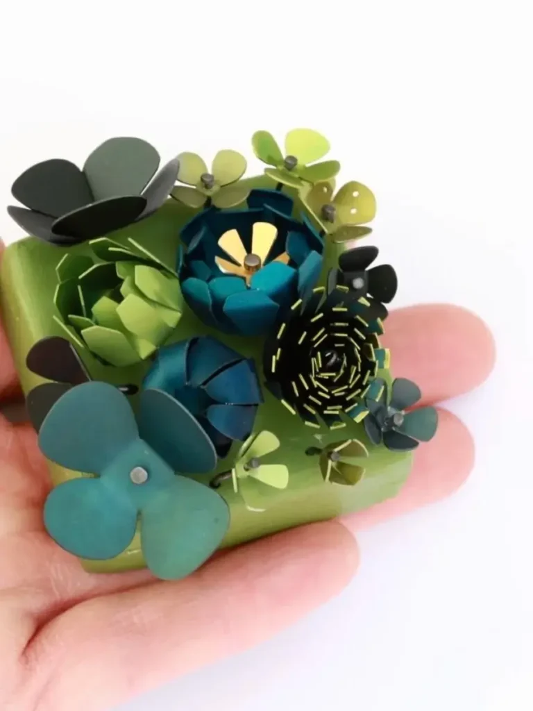 Lindsey Mann's botanical jewelry made from colored anodized aluminum and joined with tiny rivets.