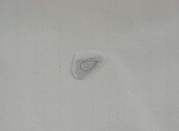 Small paper templates with pattern outlines traced on the back for cutting ribbon strands.