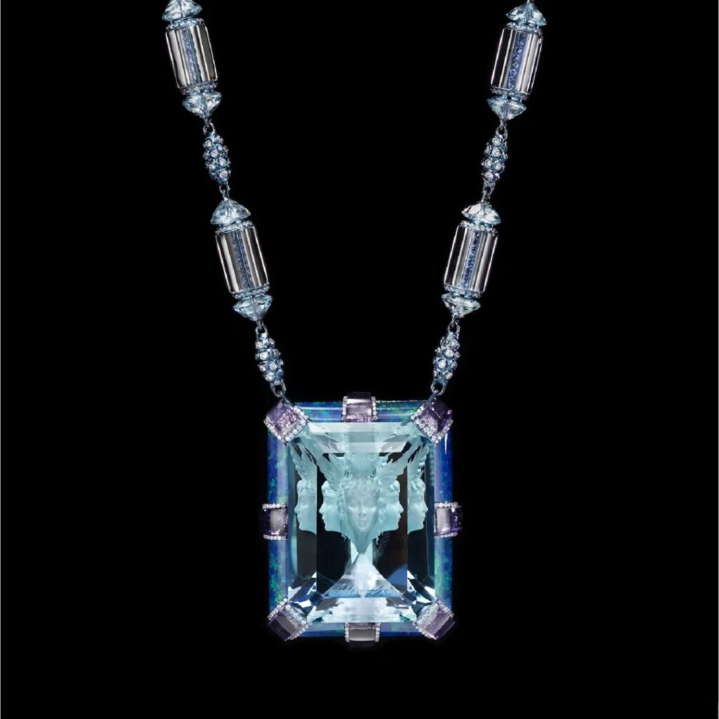 Wallace Chan aquamarine pendant featuring a reverse-carved figure viewed through the gemstone.