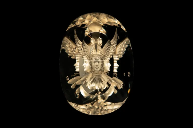Wallace Chan’s crystal carving of a goddess's face, featuring intricate details within transparent crystal.